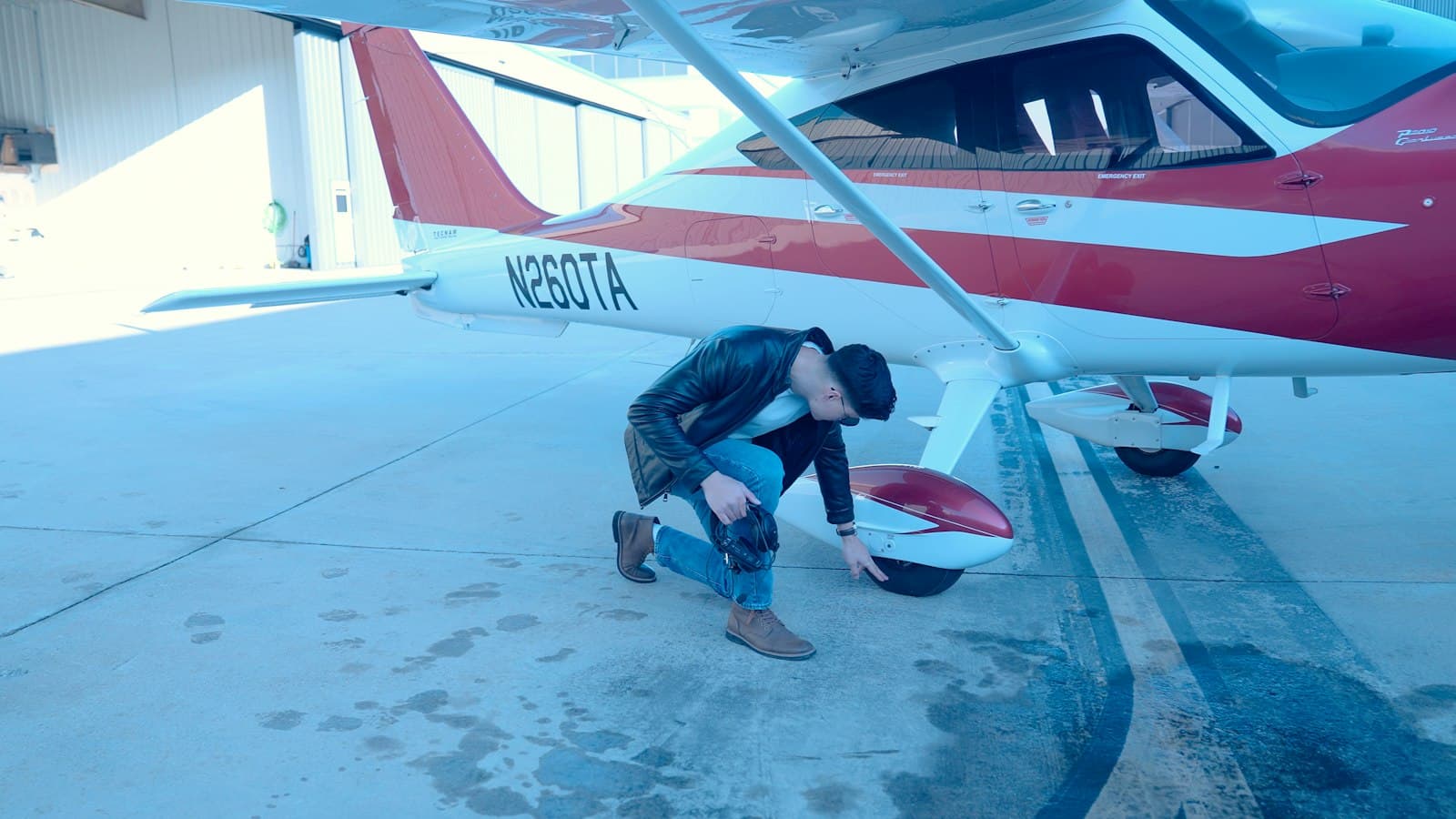 Inspector working around a small airplane in a hangar